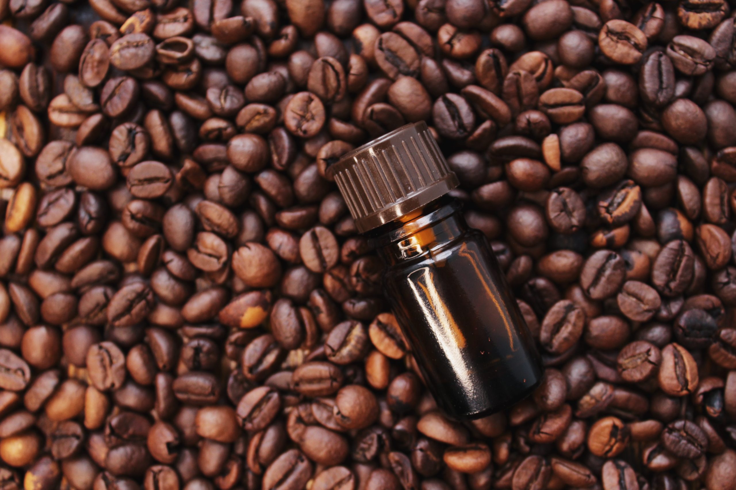 coffee-essential-oil-in-a-glass-bottle-coffee-bea-2022-11-11-21-39-00-utc-scaled-1